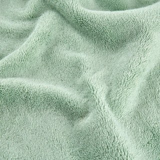 Groen bamboe handdoekset met zachte stofftextuur in close-up detail
