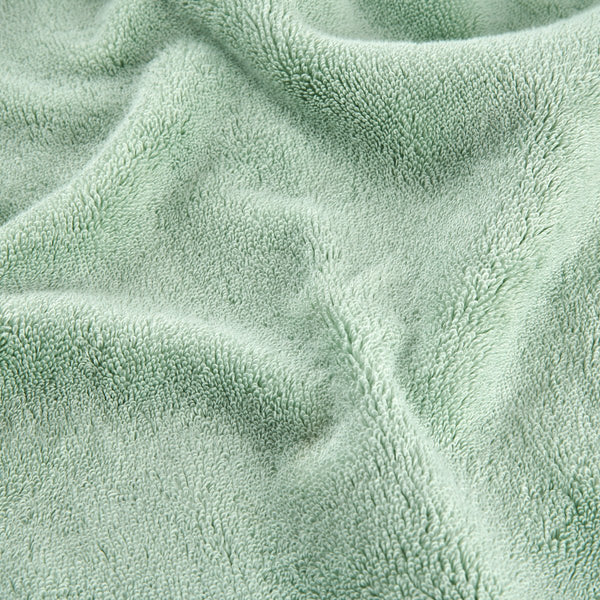 Groen bamboe handdoekset met zachte stofftextuur in close-up detail