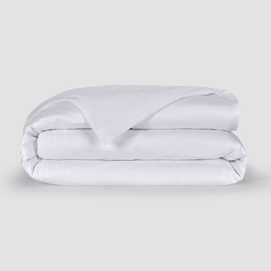 White folded duvet cover showcasing soft 100% bamboo fabric texture with hidden buttons at the bottom