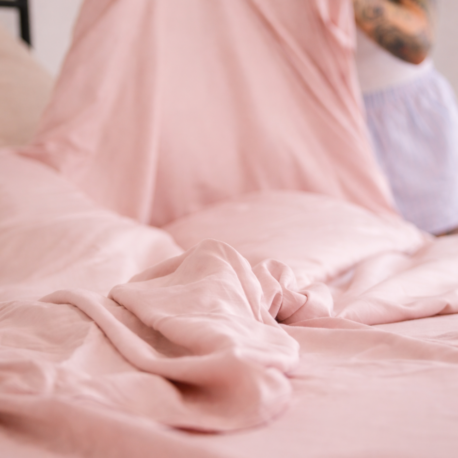 Close-up of pink bamboo bedding fabric with soft natural folds, highlighting the silky texture and breathable comfort of the pink bamboo material.